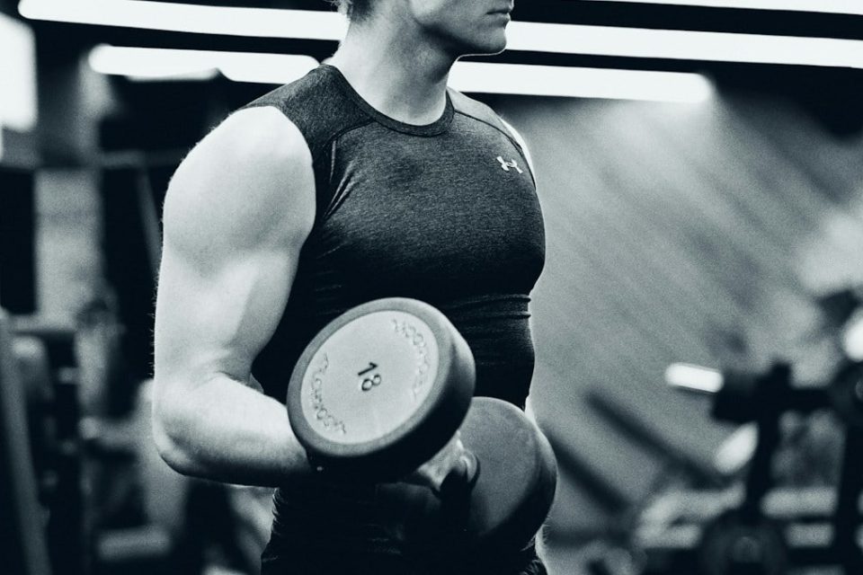 a woman holding a disc in a gym